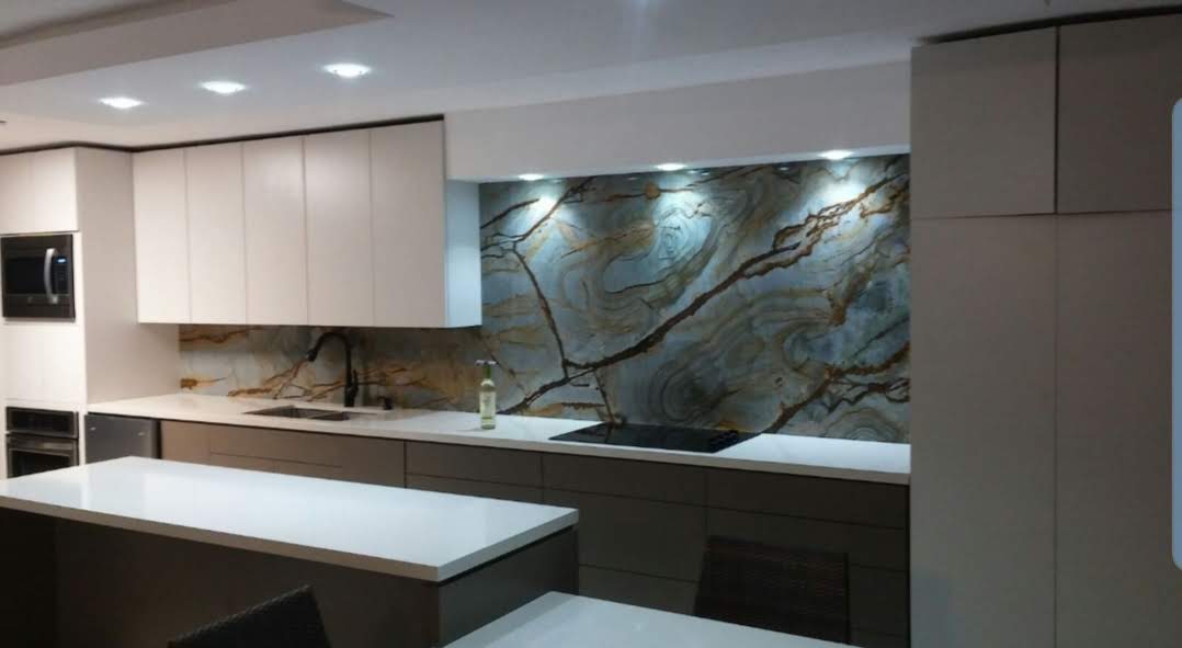 Modern kitchen with white cabinets and marble backsplash