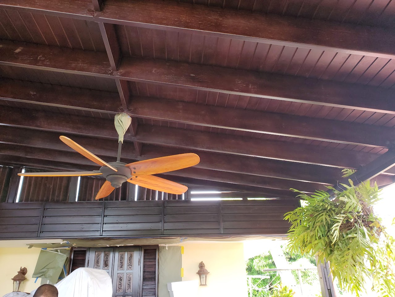 Wooden ceiling with exposed beams and ceiling fan